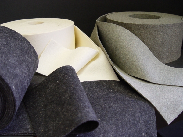 Rolls of felt in different colors, gray, cream, and black, from Accurate Felt