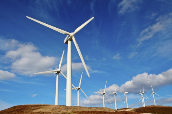 a series of wind turbines against the horizon